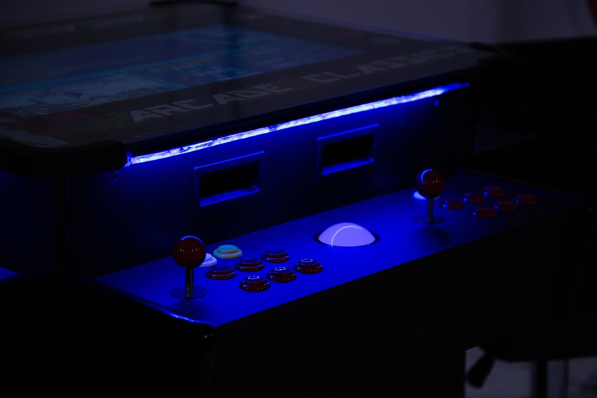 Premium cocktail arcade console features integrated blue ambient LED illumination under tournament-grade SANWA controls.