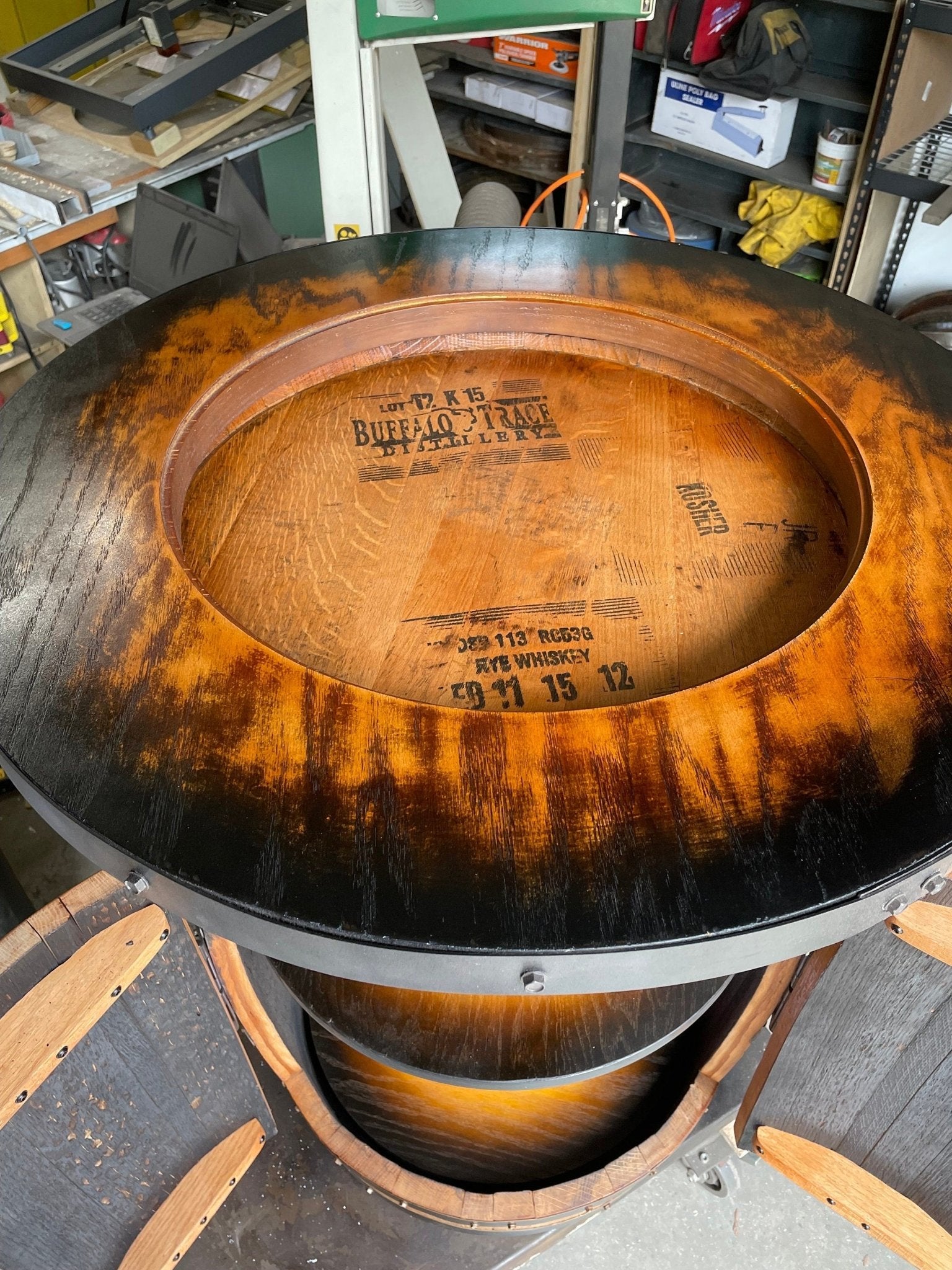 Heritage bourbon barrel table designed with clear glass top portals to display authentic original cask distillery stamps.