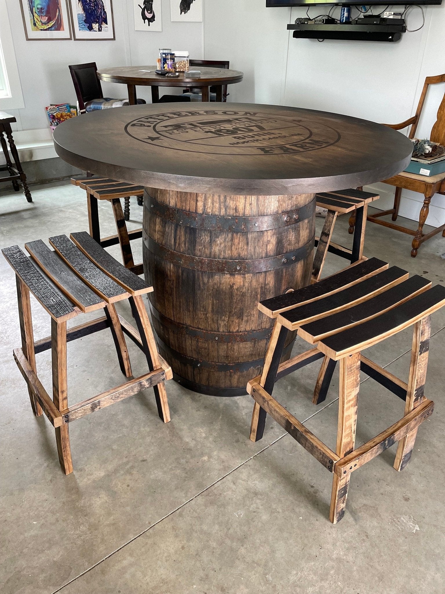 Bespoke bourbon barrel table paired with hand-carved stave seating for high-end luxury private lounges at Home Man Cave.