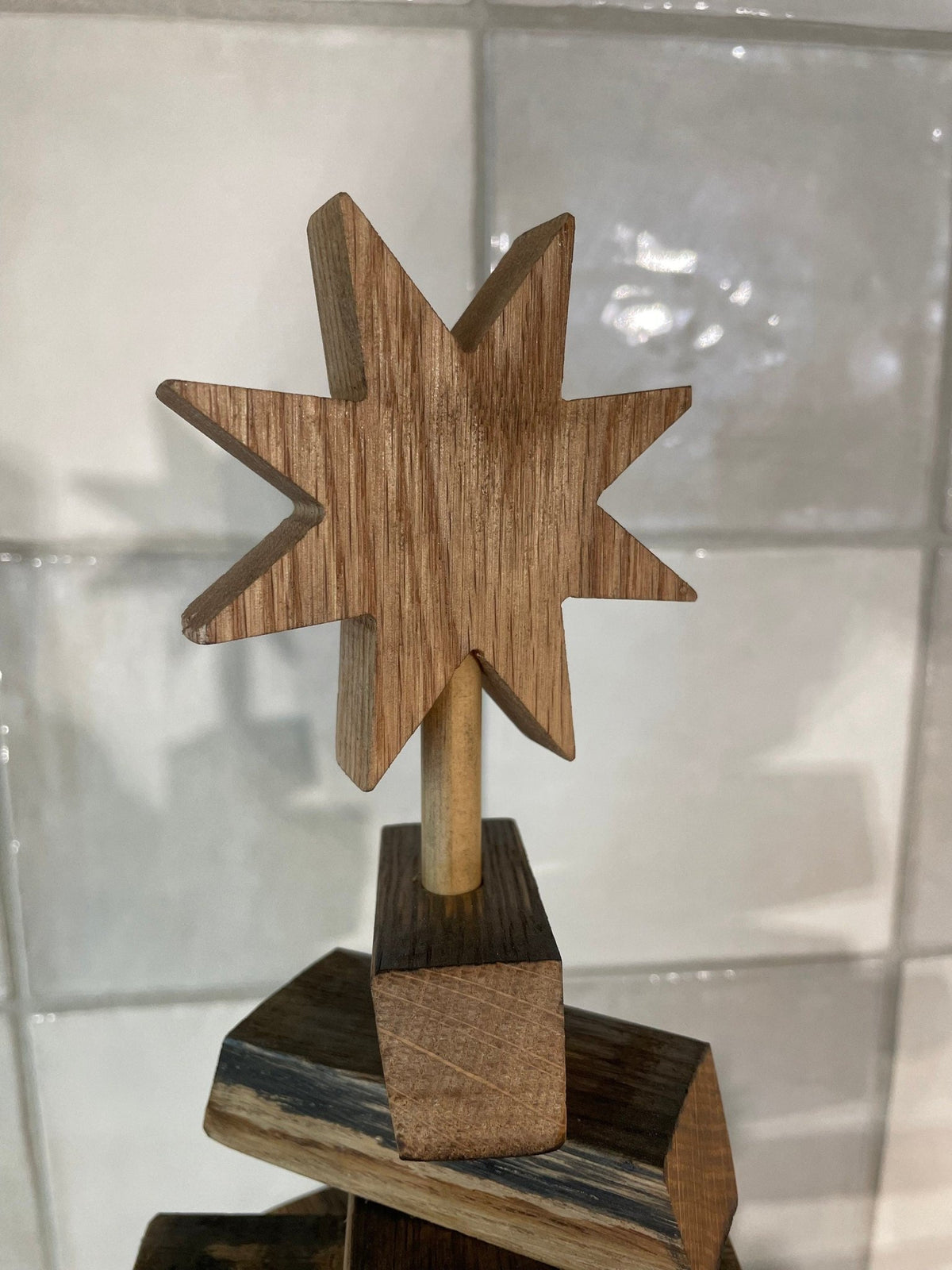 Authentic barrel christmas tree topped with an artisan hand-carved eight-point star sculpted from solid white oak timber.