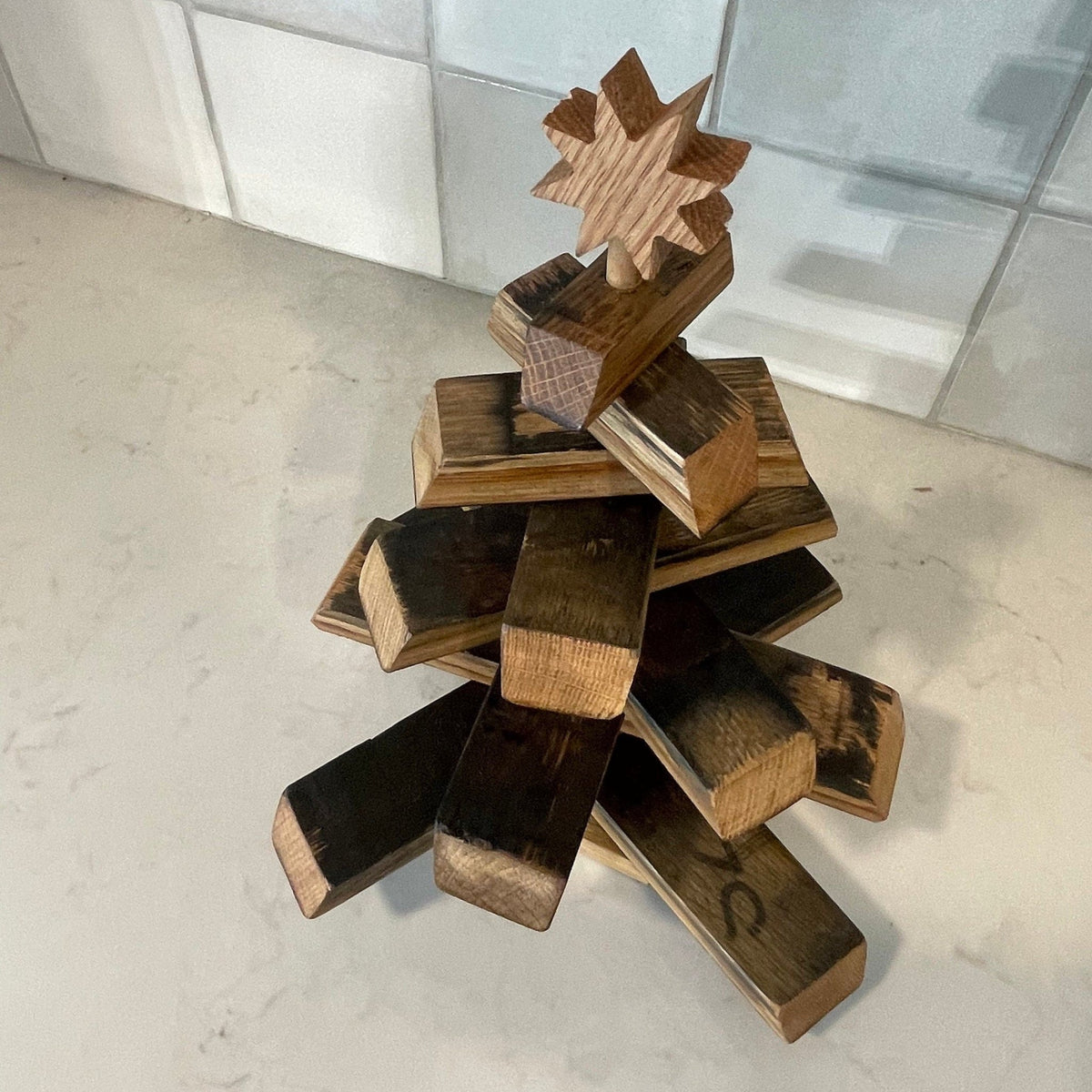 Bespoke barrel christmas tree showcasing sculptural spiral stave rotation and authentic charred distillery barrel textures.