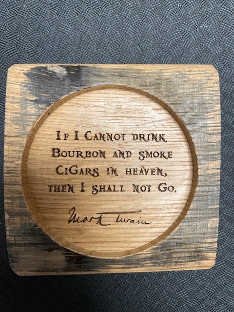 Bespoke whiskey quote coasters showcasing laser-engraved Mark Twain bourbon and cigar quotes on charred white oak staves.