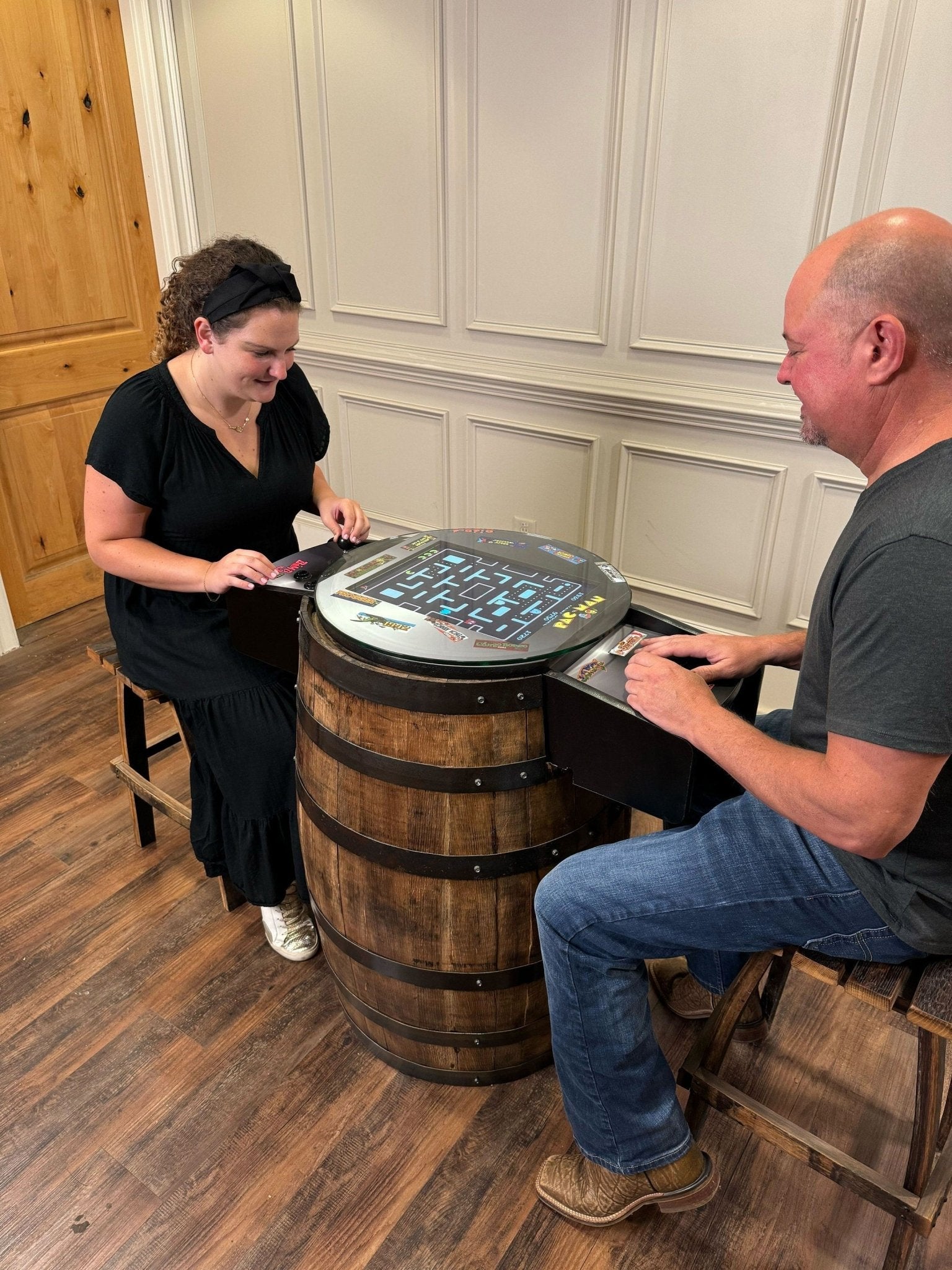 custom barrel arcade table premium high end cooperative social gaming experience rustic luxury showroom lifestyle at Home Man Cave