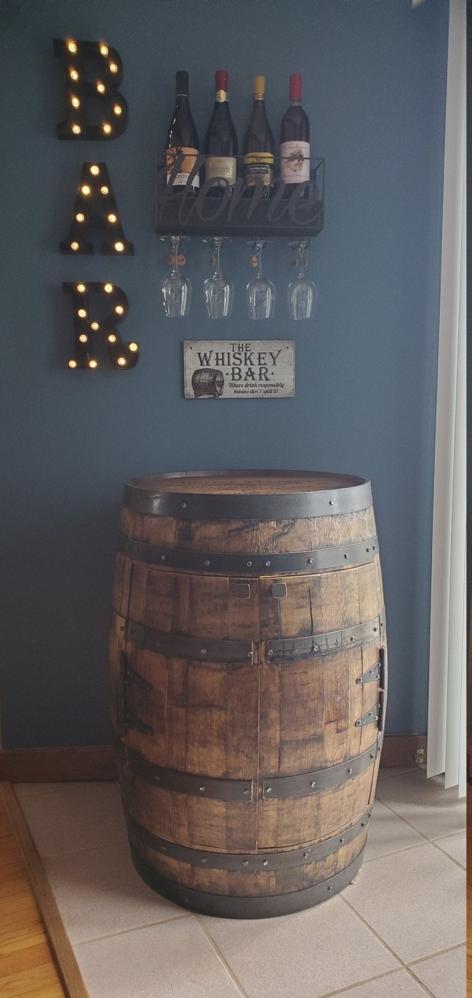 Artisan bourbon barrel cabinet offering secure magnetic closures and reclaimed wood staves for estates at Home Man Cave.