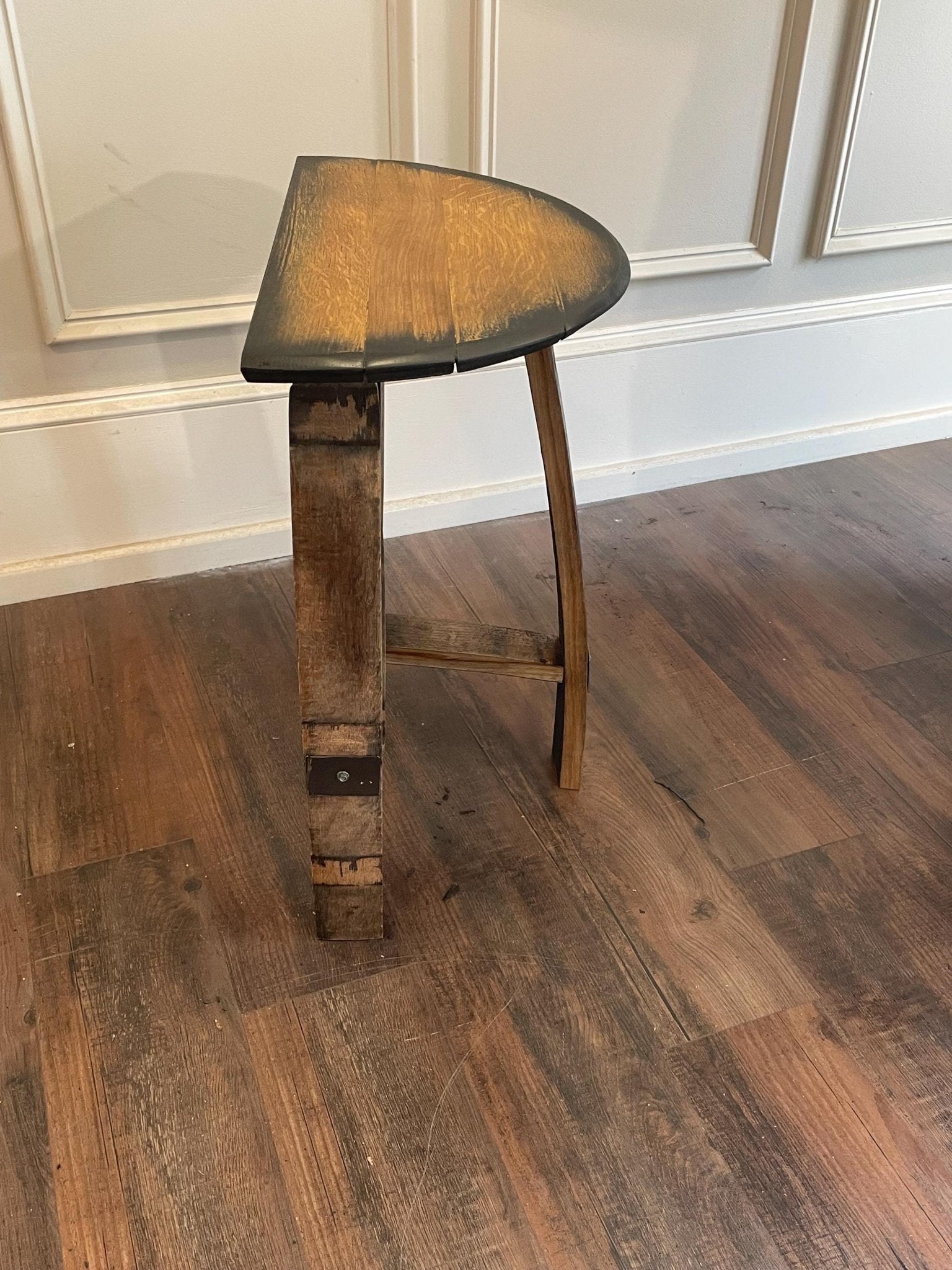Artisan bourbon bar stool showcasing natural distillery wood grain character and reinforced frame structural stability