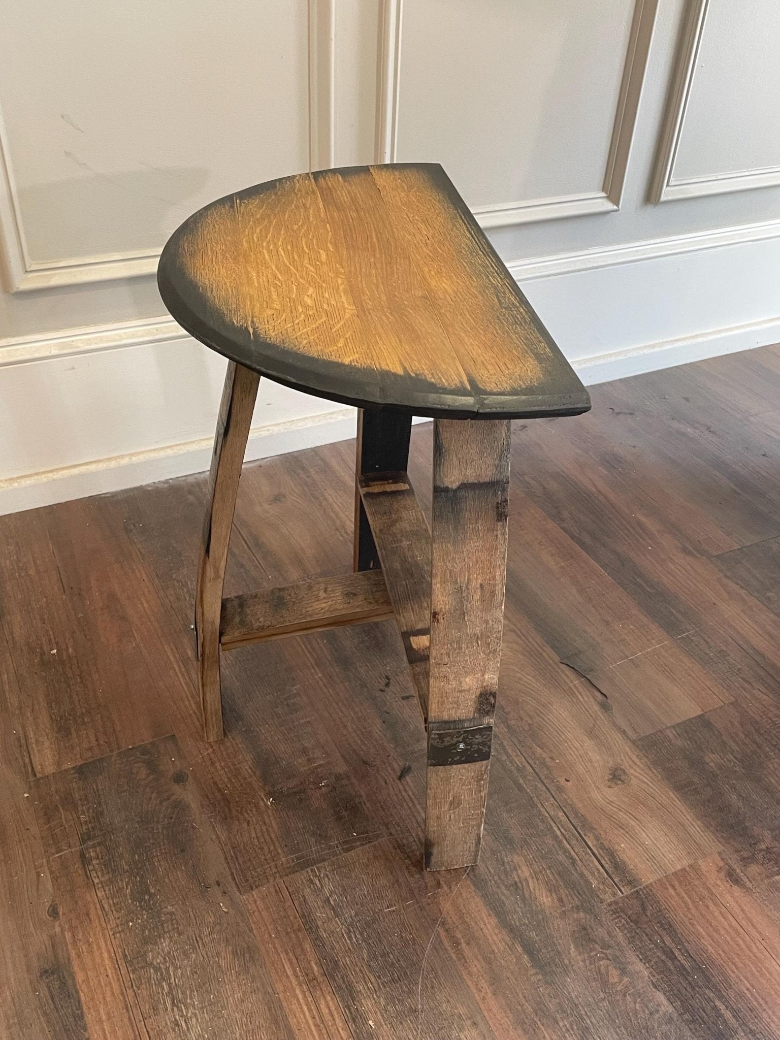 Authentic bourbon bar stool featuring a smooth spirit-aged barrel head wooden seat suitable for custom laser engraving