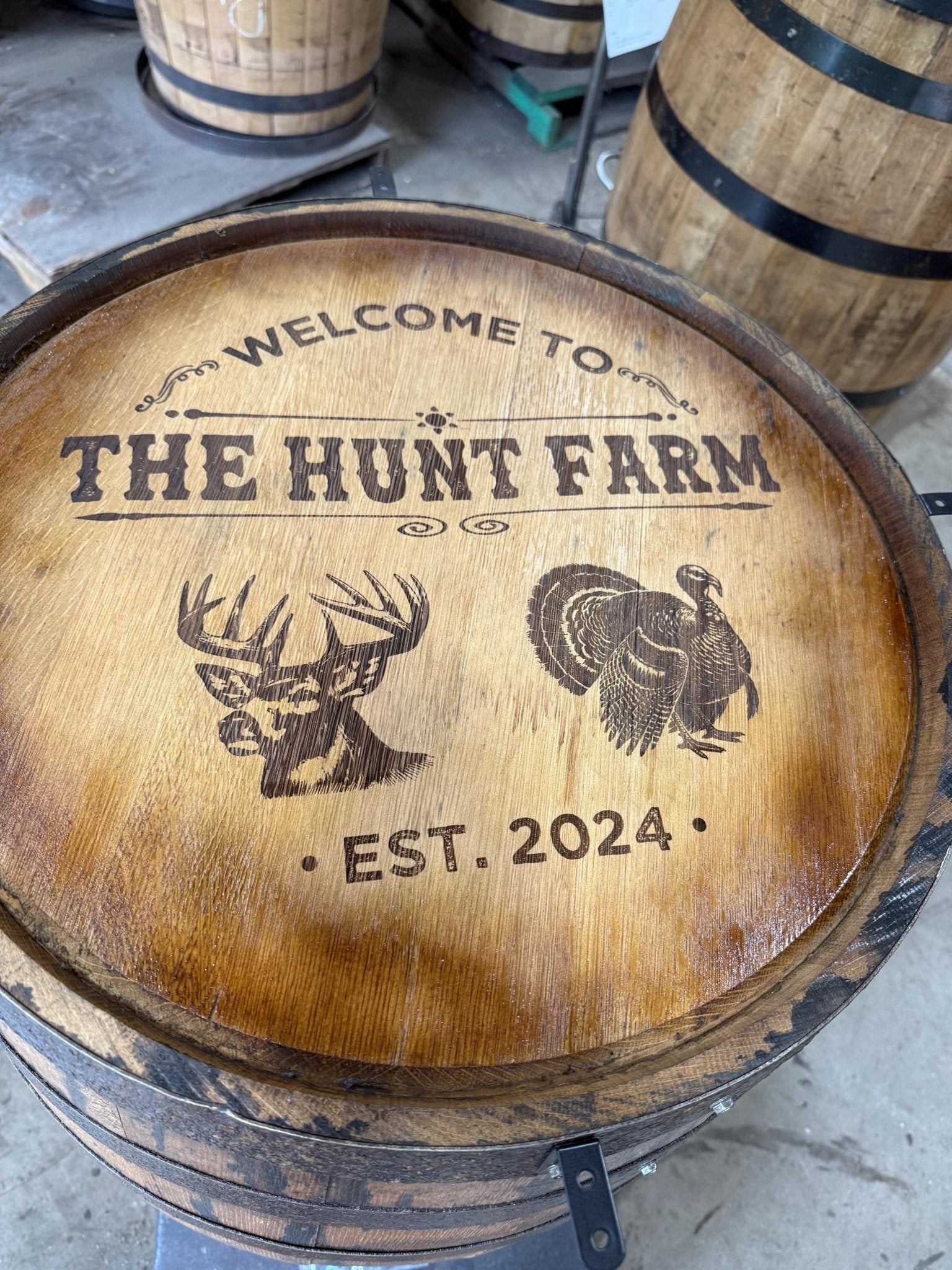 Custom barrel table featuring custom wildlife emblem laser engraving on authentic American white oak distillery lid