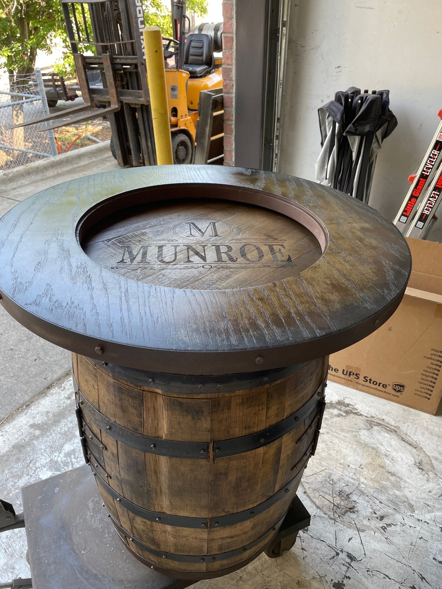 Custom barrel bistro table showcasing precision hand-finished oak wood grain and structural iron hoop bands at Home Man Cave
