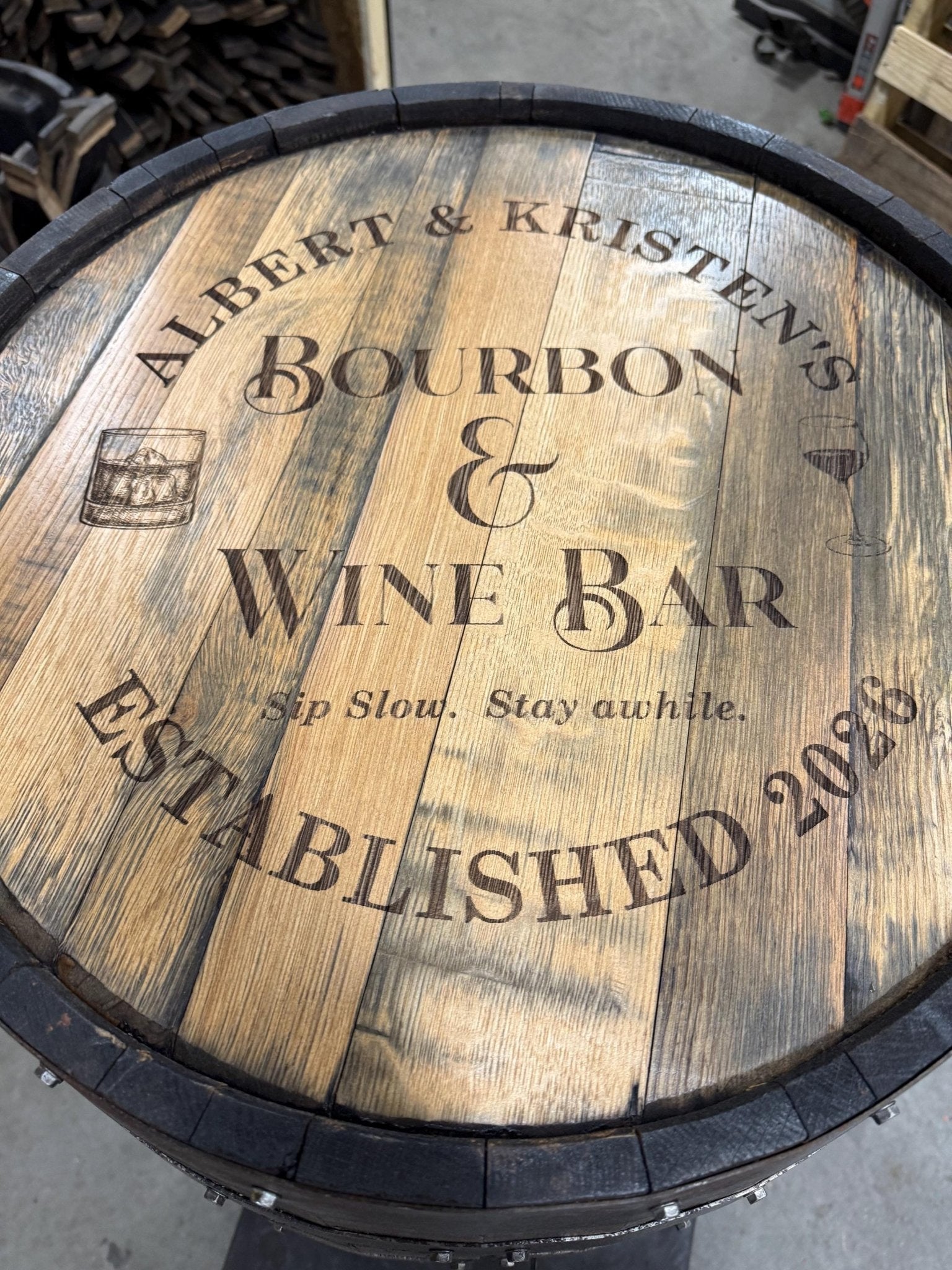Custom barrel table offering tailored laser-engraved tavern typography on reclaimed clear-coated solid oak wood lid