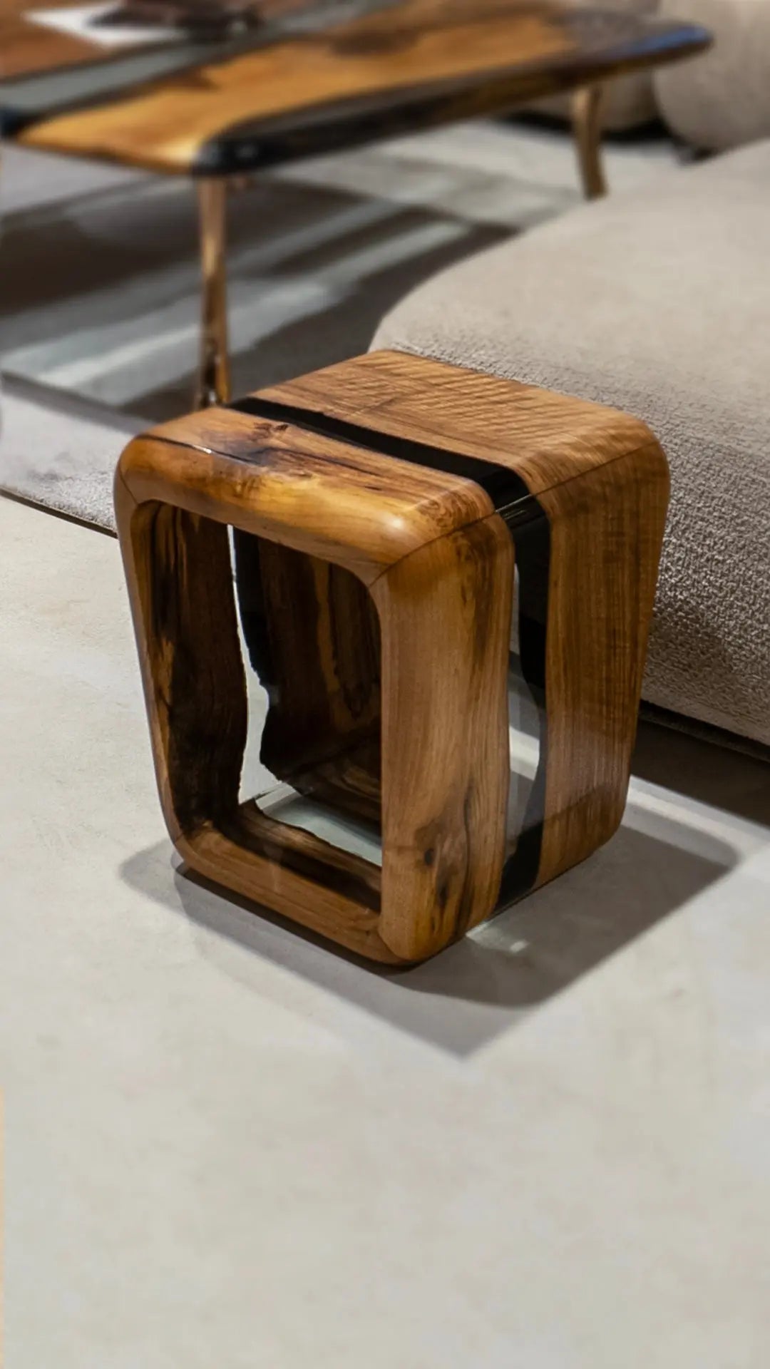 Bespoke resin side table offering versatile dual functionality as an accent magazine rack or auxiliary stool for lounges.