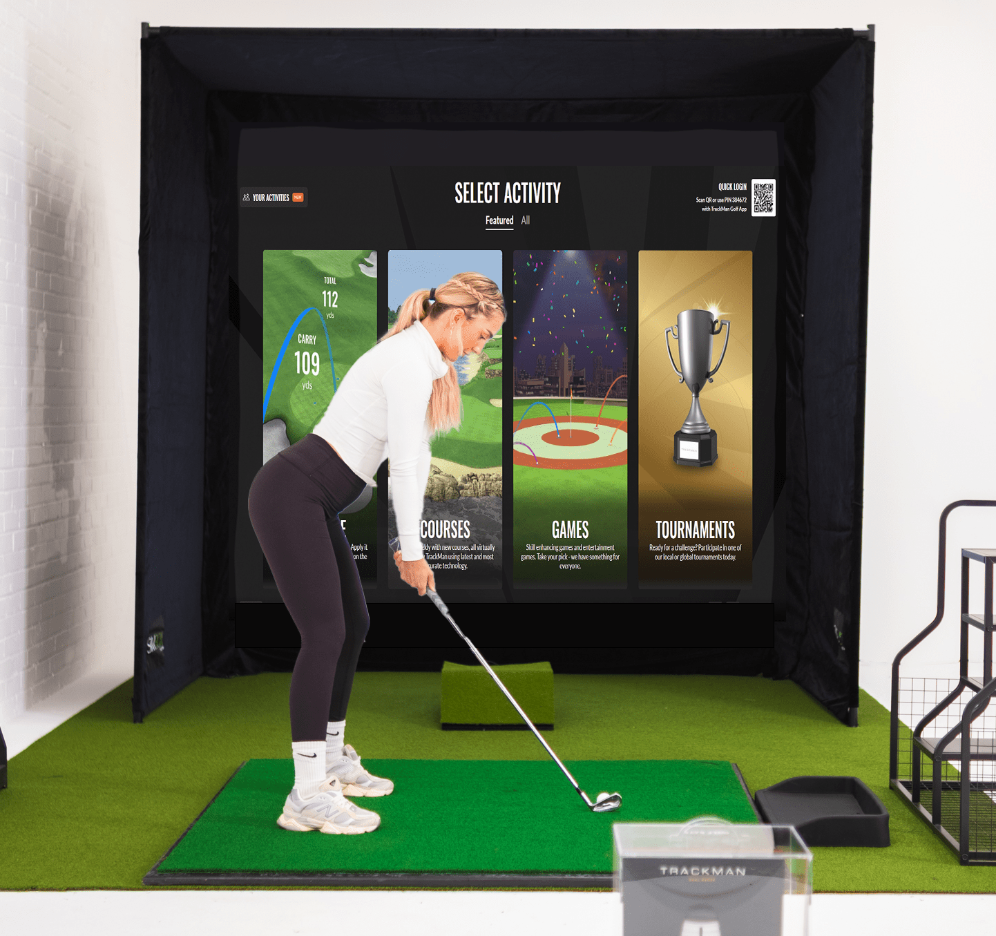 SimBox golf simulator enclosure full setup with golfer – indoor home golf studio with impact screen