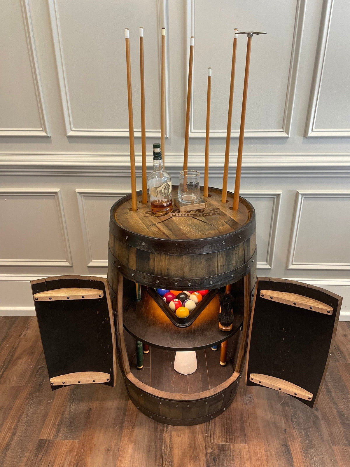 Bespoke whiskey billiards cue cabinet styled with full tournament accessory storage in luxury game lounges at Home Man Cave.