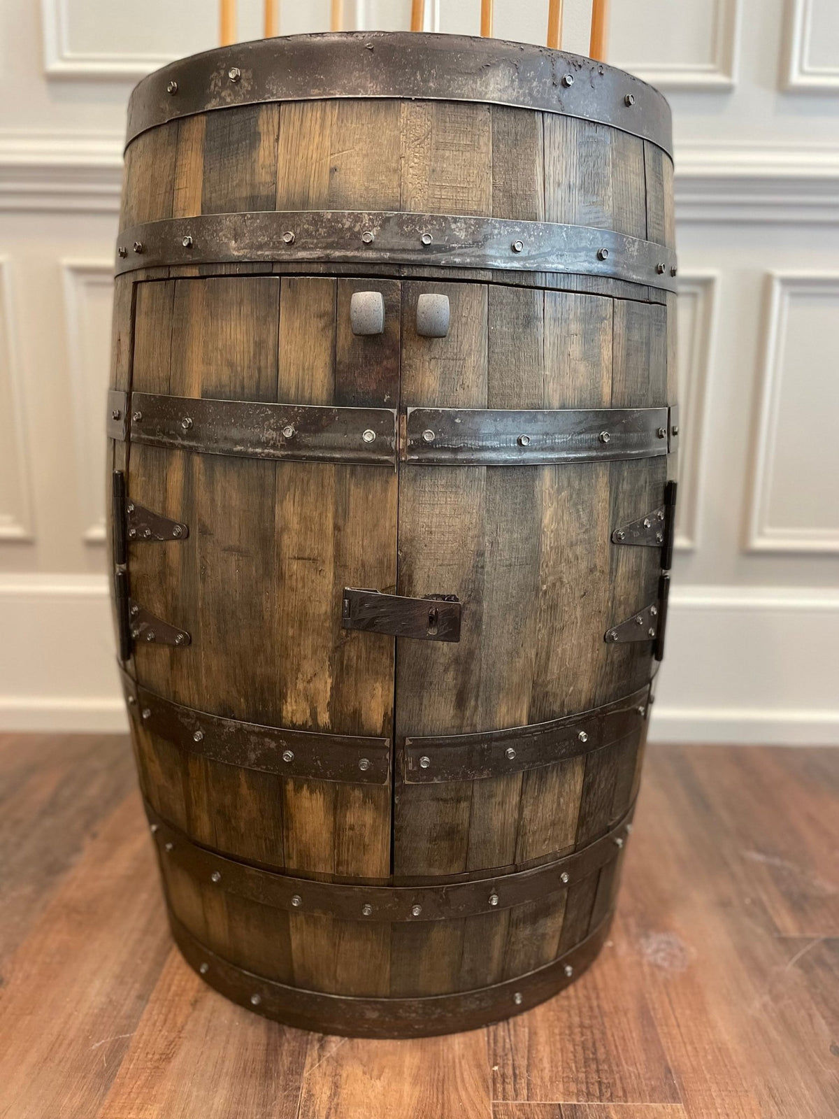 Authentic whiskey billiards cue cabinet showcasing aged spirit cask staves and steel hoops in game suites at Home Man Cave.