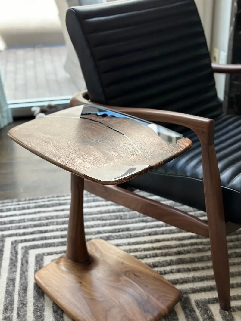 The Aurelia luxury resin table seamlessly slides over armchair seating to optimize private lounge comfort at Home Man Cave