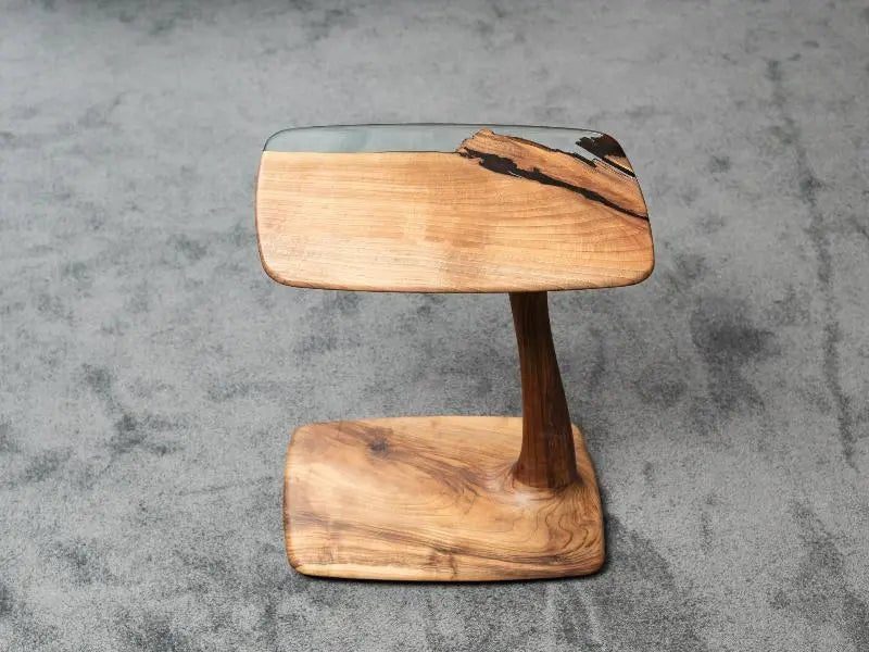 Aurelia luxury resin table engineering incorporates small sub-surface wheels for fluid metal-free side furniture movement