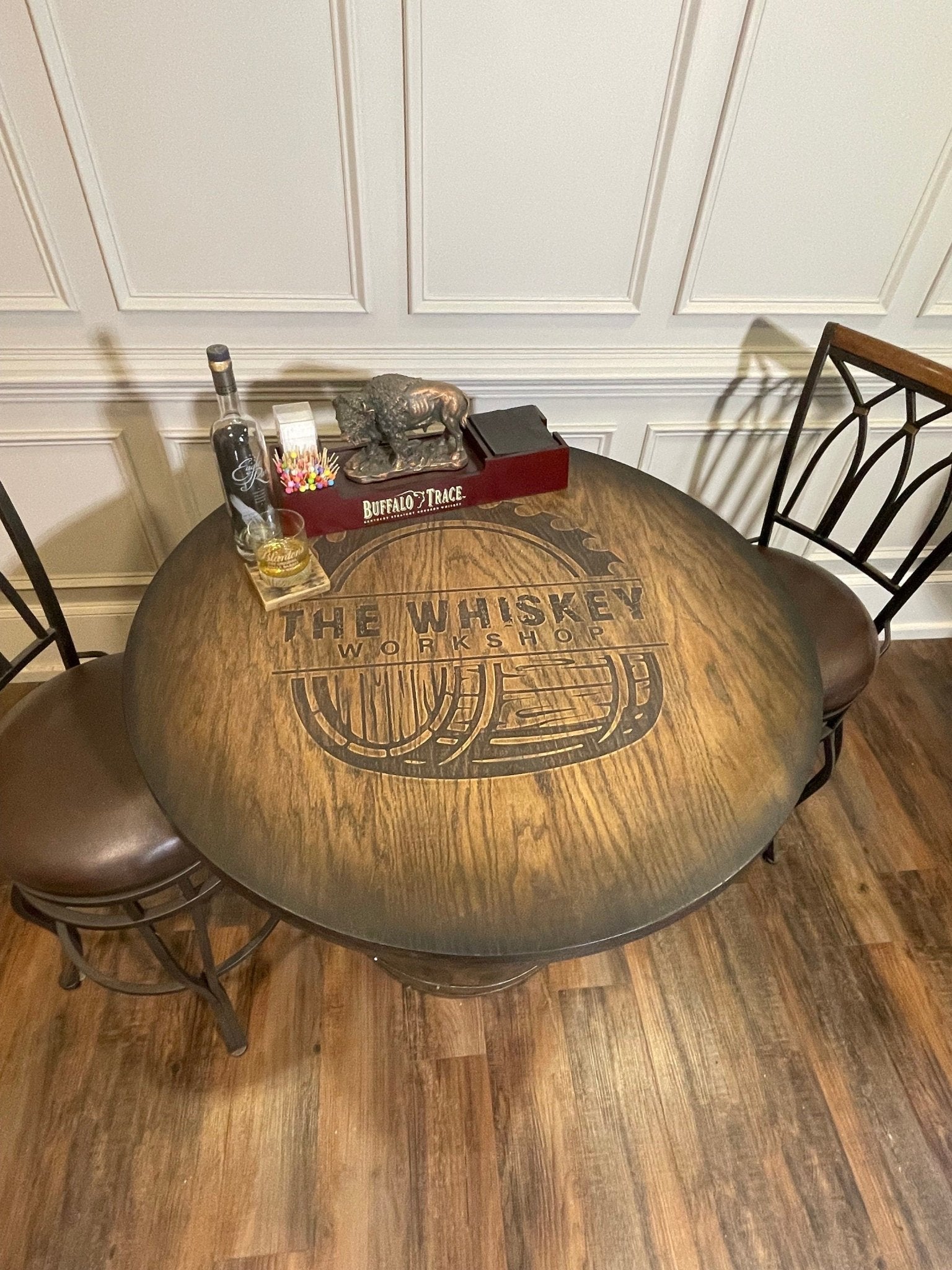 Custom bourbon barrel table showcasing precision laser-engraved heraldry for luxury private estate suites at Home Man Cave.