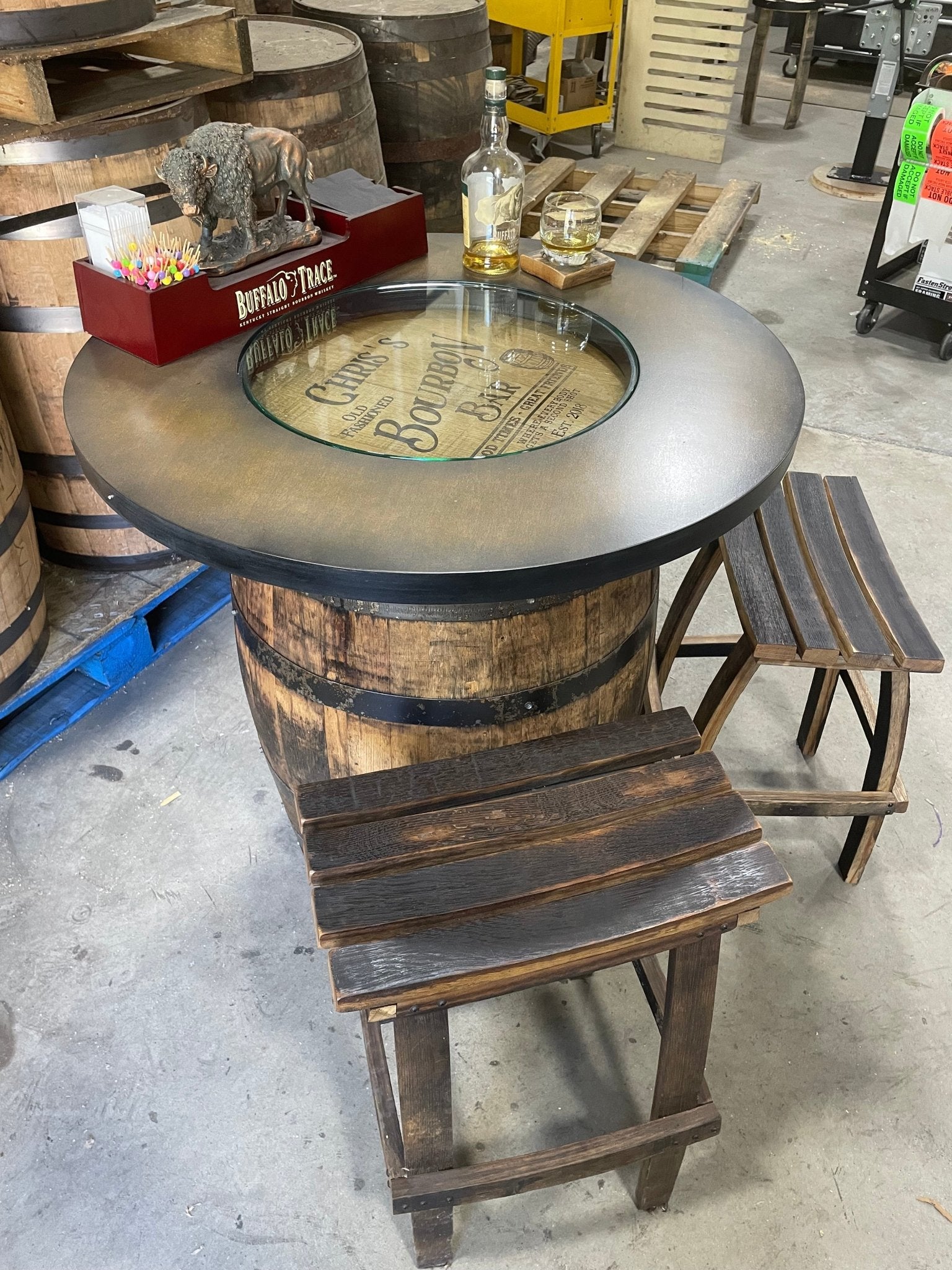 Bespoke bourbon barrel table featuring an inset glass viewing portal to elevate luxury estate home bars at Home Man Cave.
