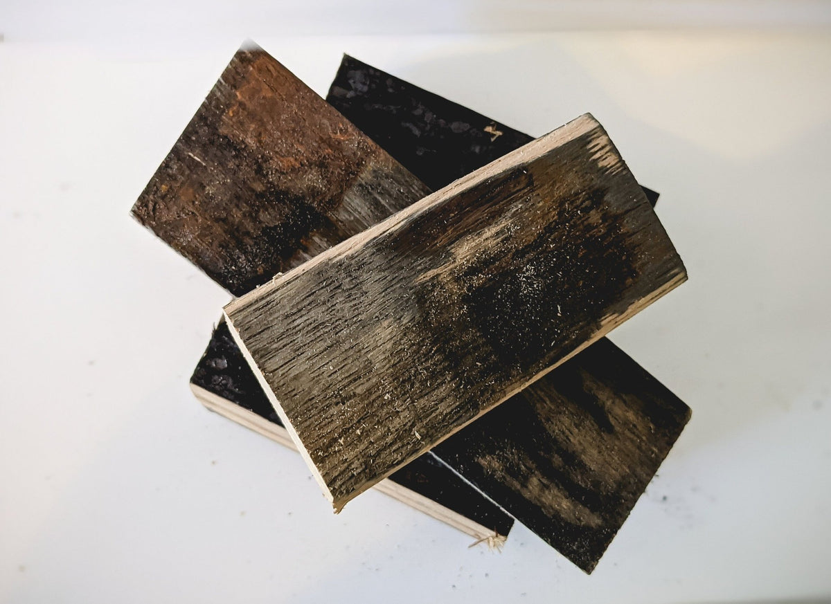 Bespoke bourbon barrel smoking wood showcasing authentic charred stave surfaces infused with rich aged distillery aromas.