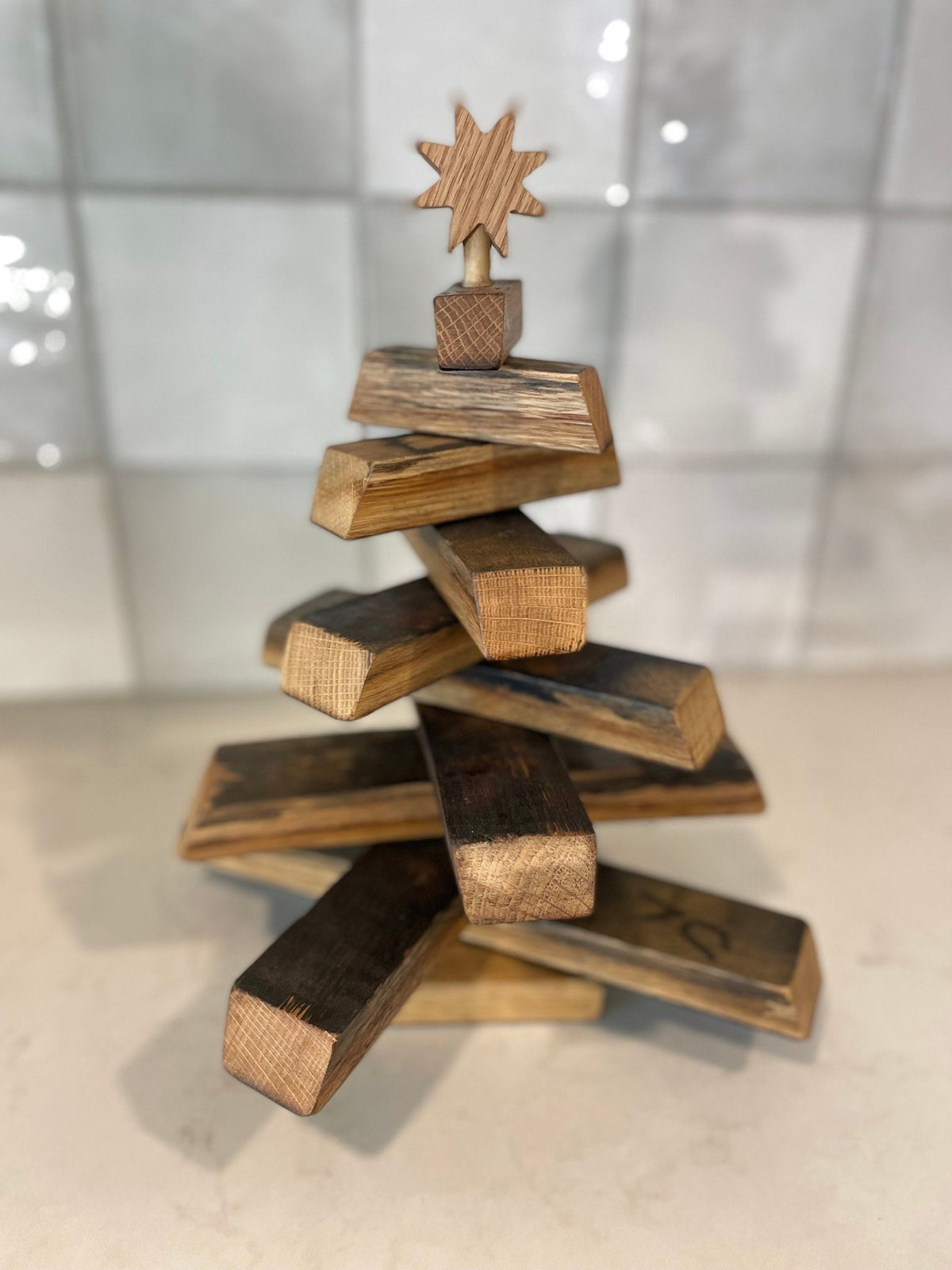 Artisan barrel christmas tree crafted with full three-hundred-sixty-degree rotating staves on a solid metal center spine.