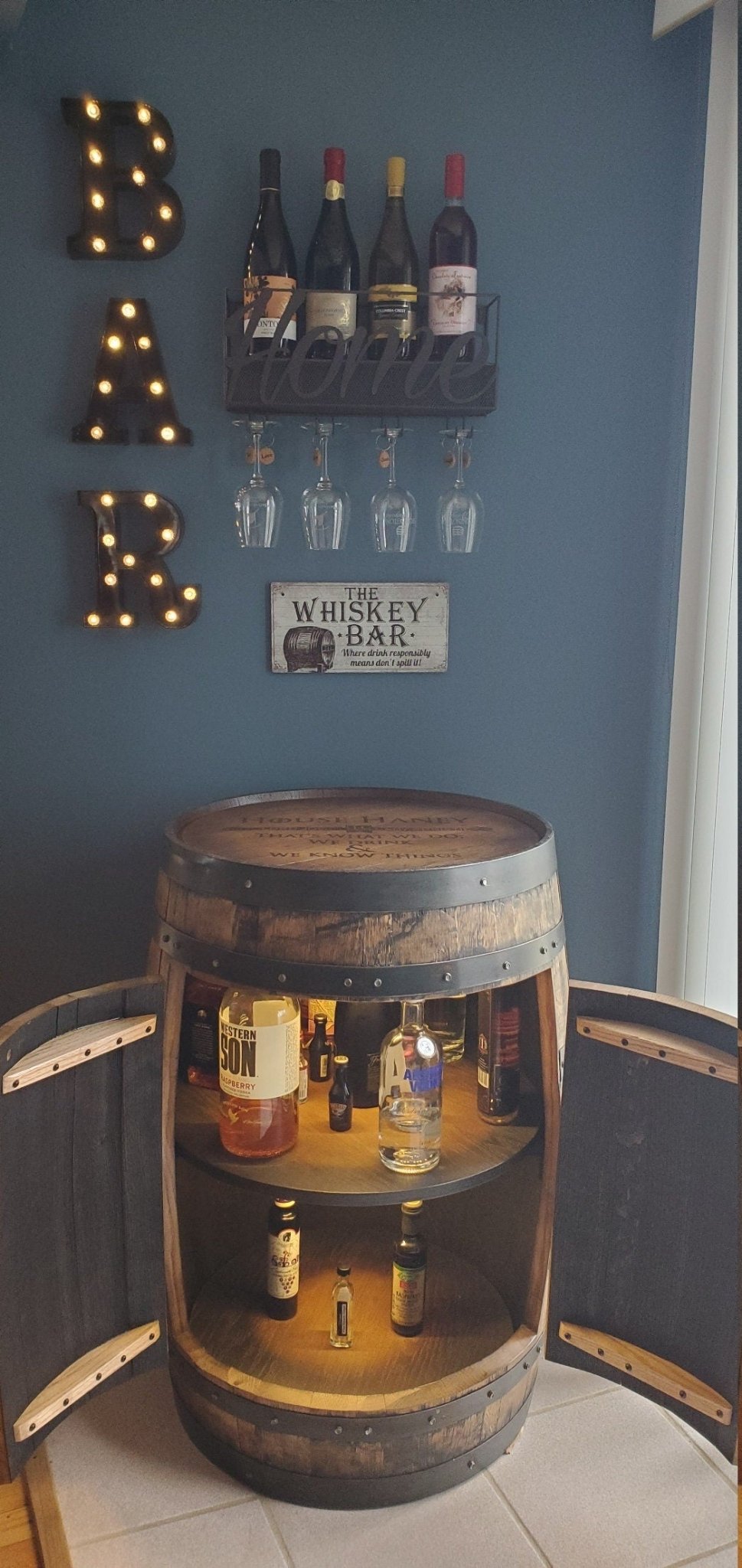 Custom bourbon barrel cabinet featuring sealed anti-dust interior finishes for luxury estate bar suites at Home Man Cave.