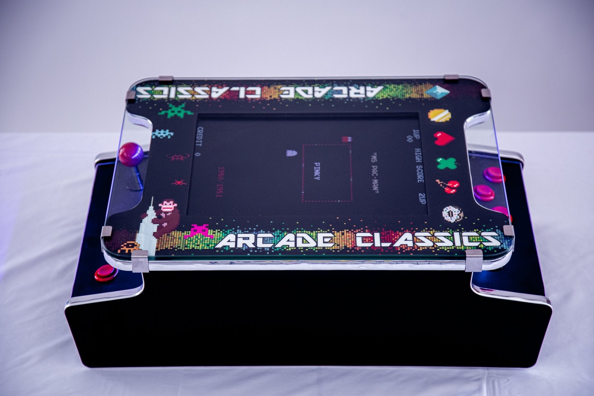 Elite tabletop arcade console features a premium fifteen inch LCD monitor encased beneath artisan tempered safety glass armor