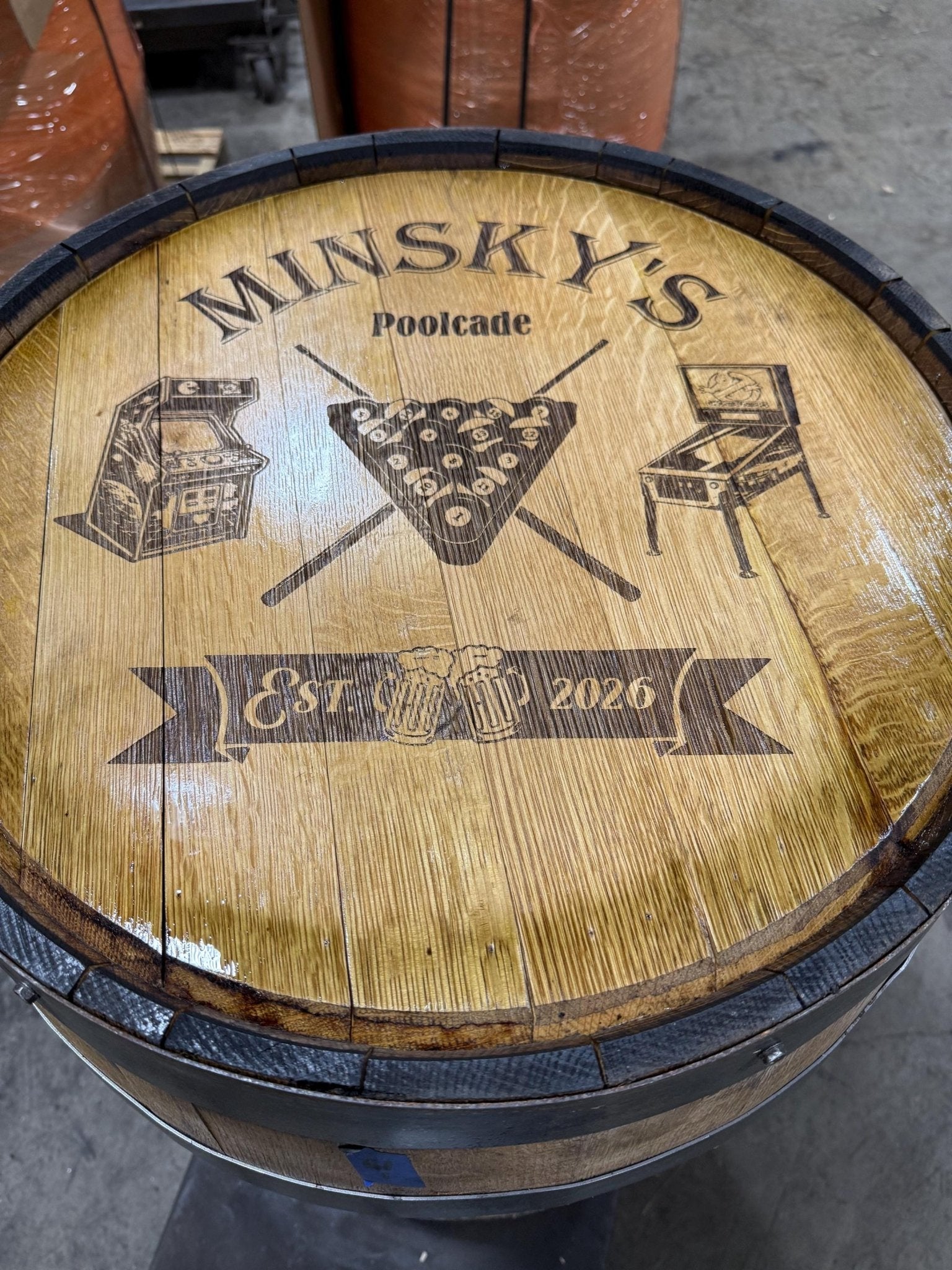 Handcrafted bourbon barrel table built with personalized laser engraved barrel head art sealed under protective interior coat