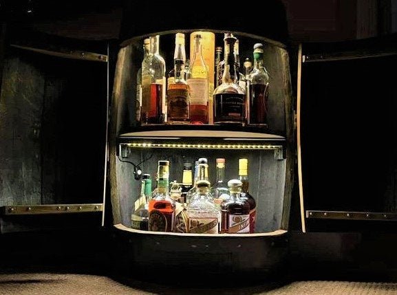 Bespoke bourbon barrel table equipped with motion activated interior LED lighting and dual tier rotating liquor shelves