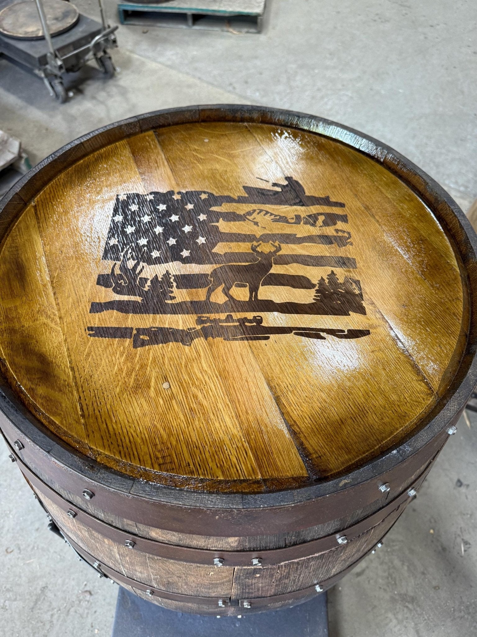 Custom barrel table featuring patriotic flag emblem laser carving on solid hand-sanded bourbon barrel head timber
