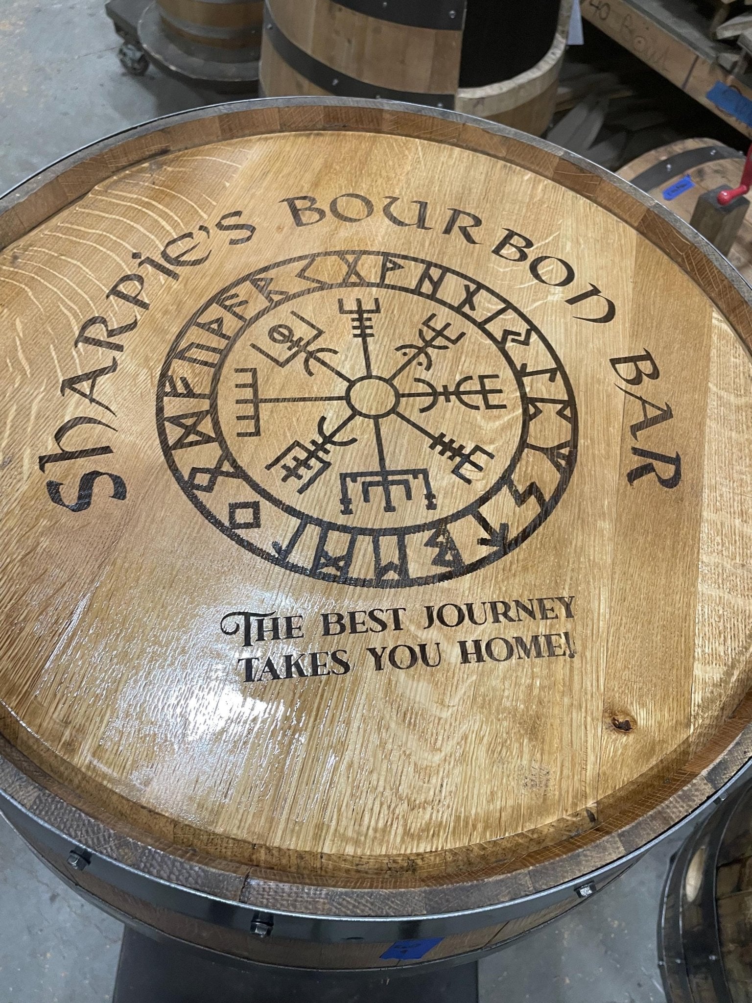 Handcrafted custom barrel table featuring a sanded and sealed clear-coated finish designed for artisanal interior estate bar use