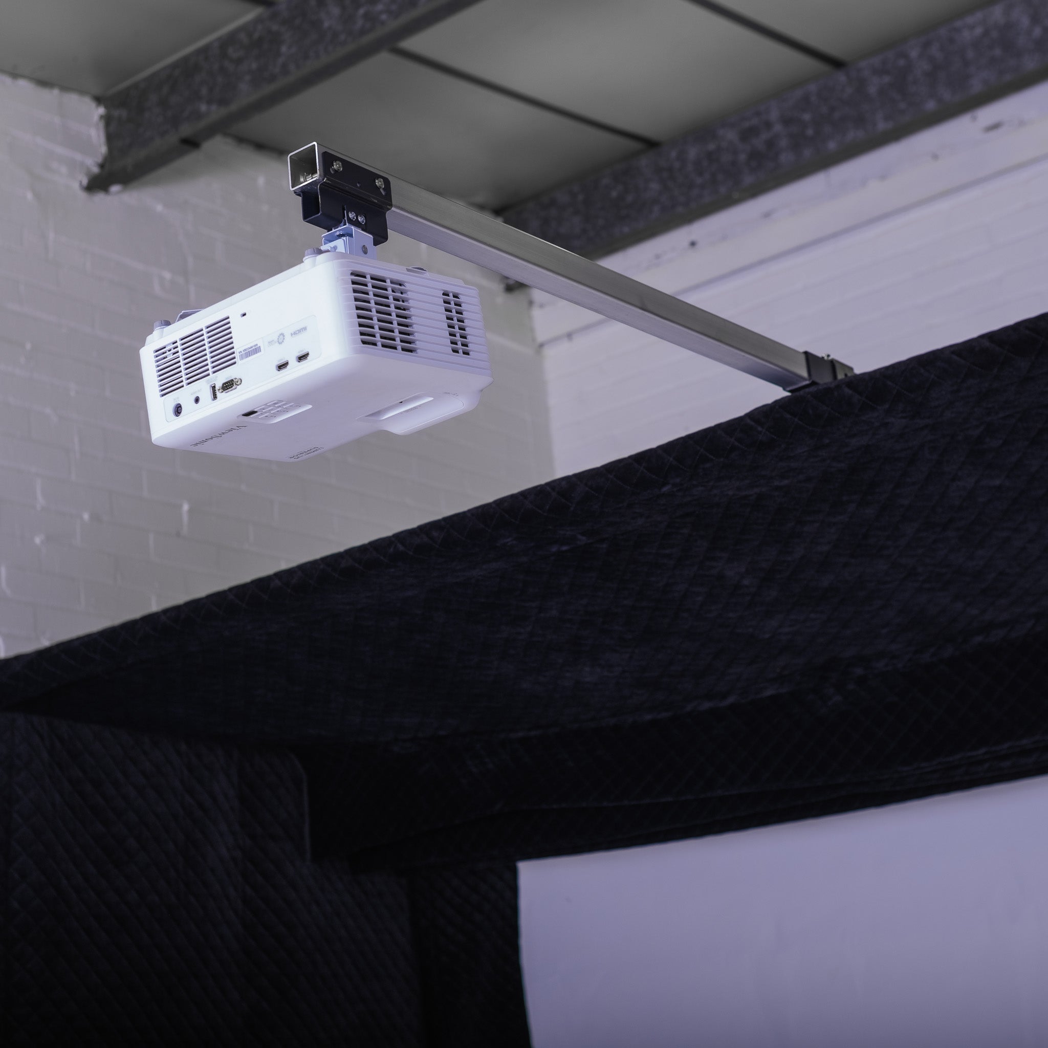 GolfBays Lux golf simulator enclosure – close-up of projector mount and tech setup
