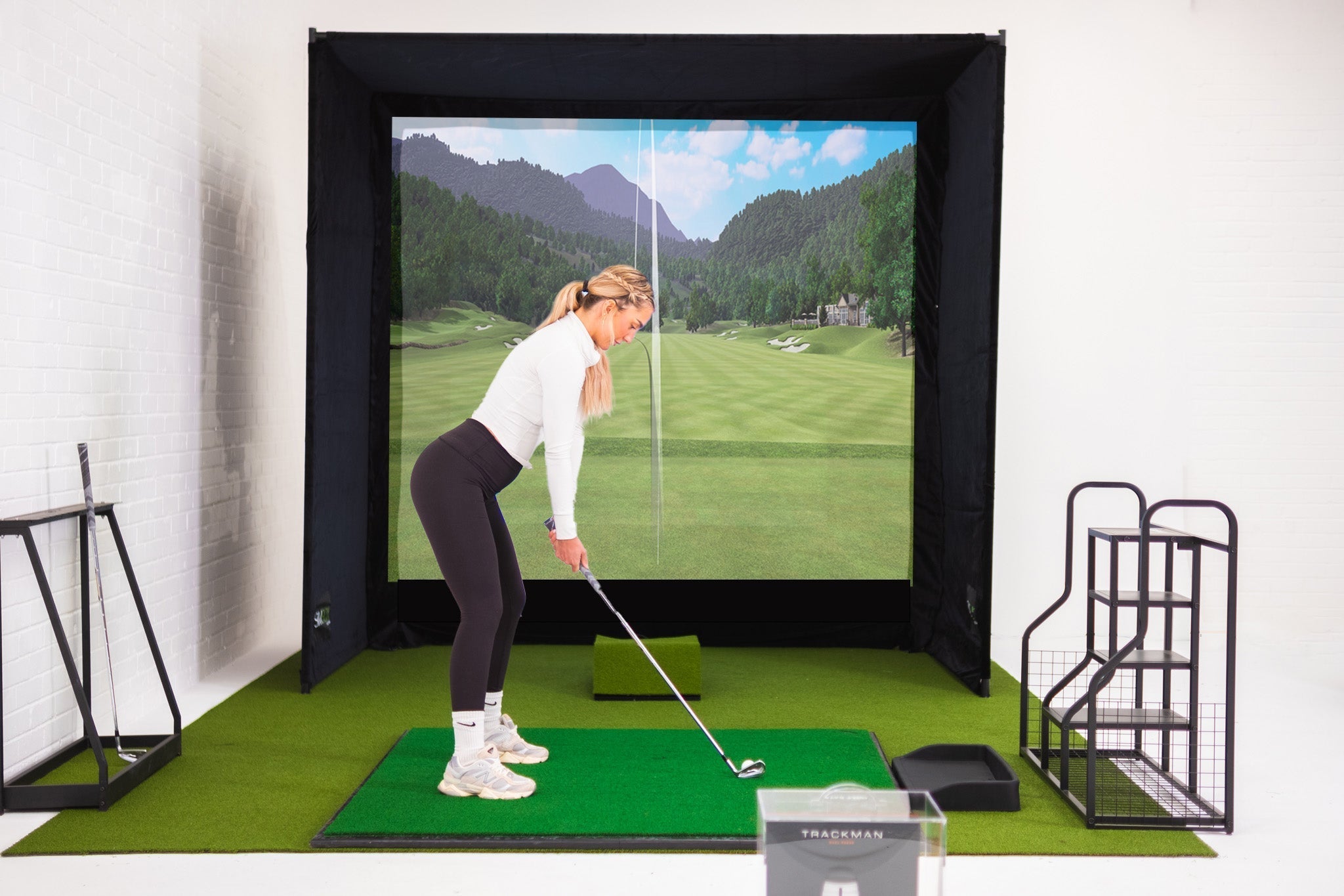 SimBox golf simulator enclosure in small room setup – compact indoor golf bay with impact screen