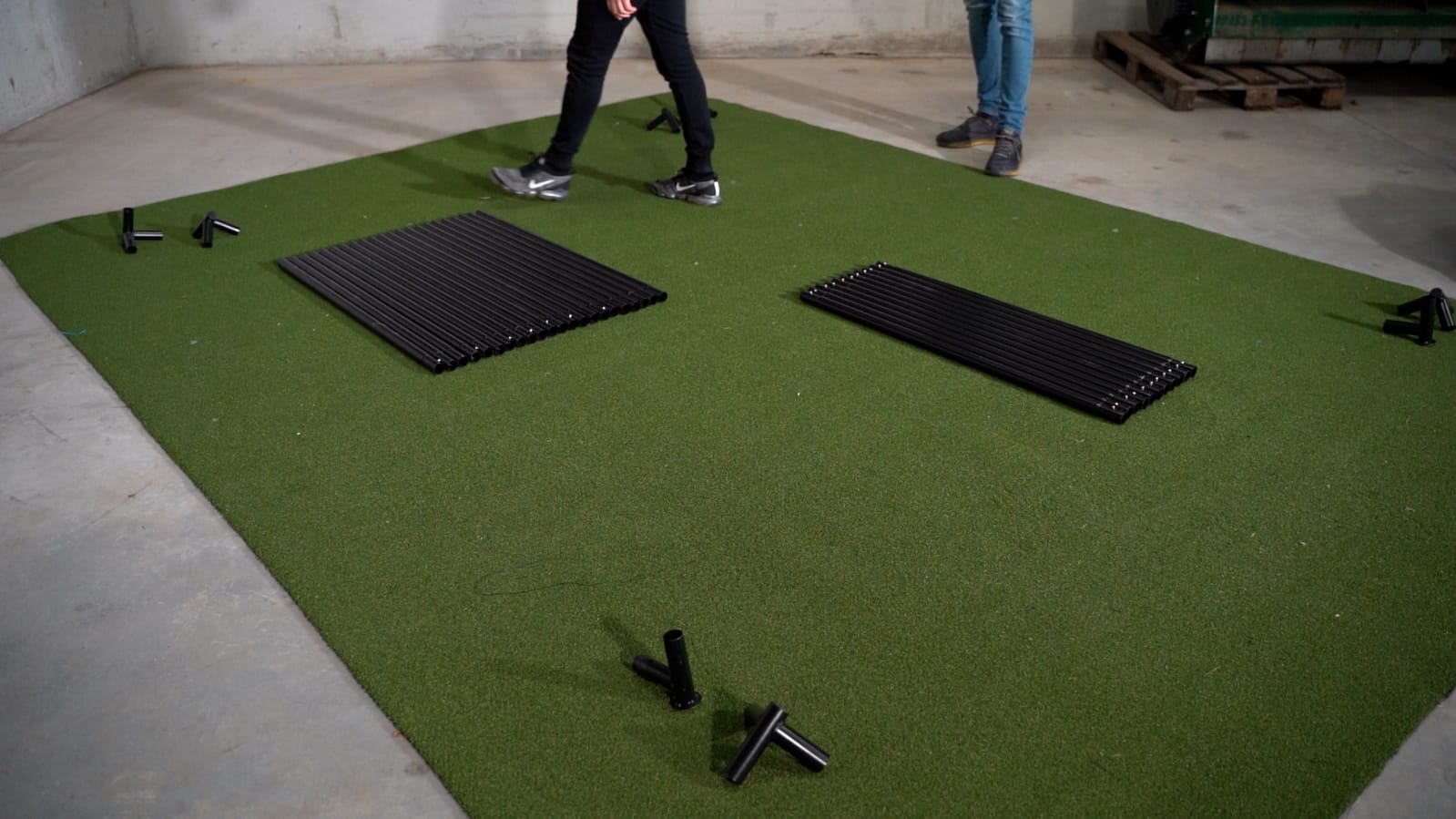 SimBox golf simulator enclosure frame assembly in progress – easy home installation on green mat