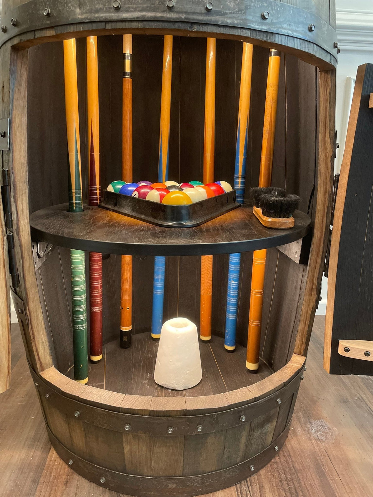Artisan whiskey billiards cue cabinet equipped with integrated 50,000-hour LED downlights and solid white oak ball shelving.