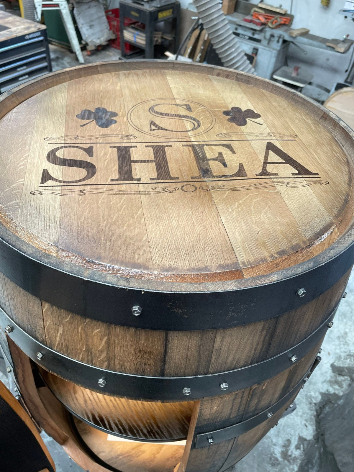 Authentic whiskey billiards cue cabinet detailed with precision laser-engraved monogram heraldry on white oak cask tops.